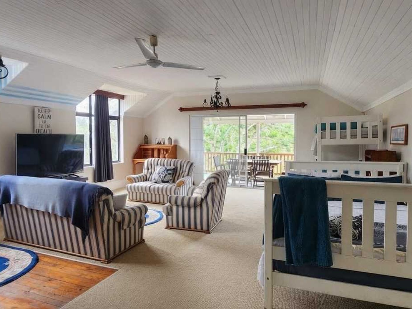 Lounge with double bunk, TV and sliding doors to the verandah