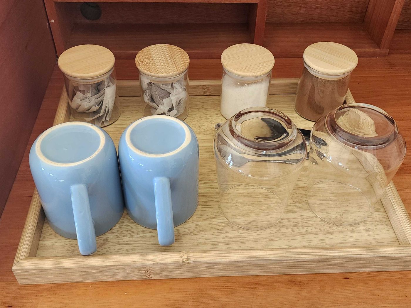 Tea and coffee tray with mugs and glasses
