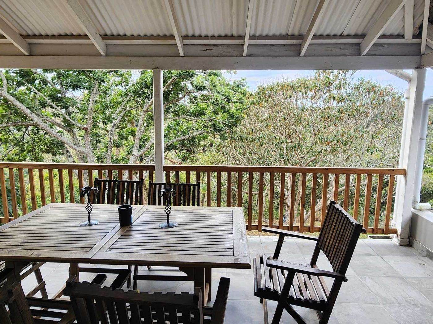 Covered verandah with dining table and chairs